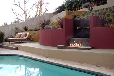 This is an example of a large and australian native contemporary sloped full sun garden in Los Angeles with a fire feature and natural stone pavers.