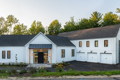Example of a farmhouse exterior home design in Portland Maine