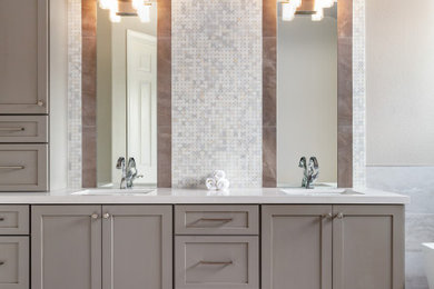 Large transitional master white tile and marble tile porcelain tile, beige floor and double-sink freestanding bathtub photo in Los Angeles with shaker cabinets, gray cabinets, beige walls, quartz countertops, white countertops and a built-in vanity