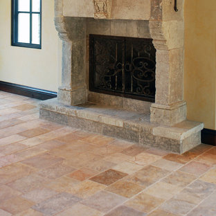 Inspiration for a large mediterranean formal open plan living room in Los Angeles with multi-coloured walls, a standard fireplace, a stone fireplace surround, no tv and limestone flooring.