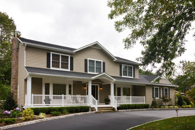 Inspiration for a mid-sized traditional two-storey beige house exterior in New York with wood siding, a gable roof and a shingle roof.