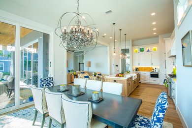 Large beach style open plan dining in Jacksonville with white walls, light hardwood floors and no fireplace.