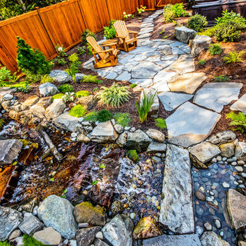 Waterfall and pond flanked by natural stone