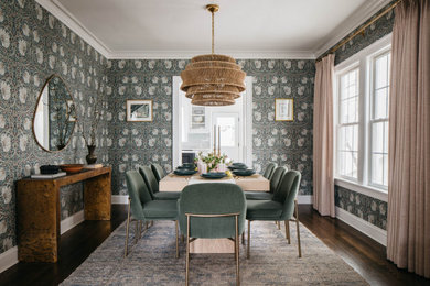 Example of a transitional dark wood floor, brown floor and wallpaper enclosed dining room design in Chicago with multicolored walls