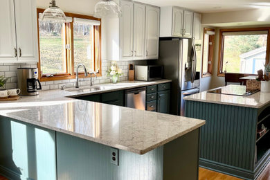 Example of a mid-sized transitional l-shaped light wood floor eat-in kitchen design in Detroit with an undermount sink, raised-panel cabinets, green cabinets, quartz countertops, white backsplash, subway tile backsplash, stainless steel appliances, an island and beige countertops