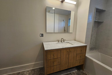 Example of a trendy master bathroom design in New York with furniture-like cabinets and a freestanding vanity