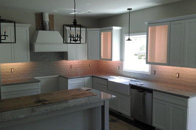 Example of a mid-sized trendy l-shaped eat-in kitchen design in Other with an island and white countertops