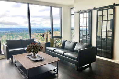 Example of a mid-sized urban open concept dark wood floor and brown floor living room design with white walls, a standard fireplace, a stone fireplace and a wall-mounted tv