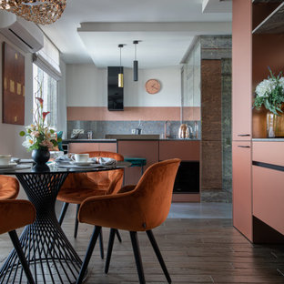 Design ideas for a small contemporary galley eat-in kitchen in Yekaterinburg with an undermount sink, flat-panel cabinets, pink cabinets, granite benchtops, grey splashback, granite splashback, coloured appliances, porcelain floors, with island, grey floor, grey benchtop and wallpaper.