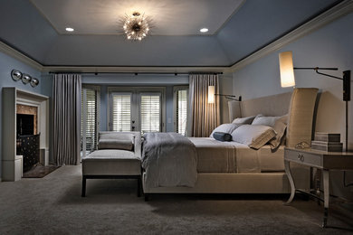 This is an example of a large transitional master bedroom in Detroit with blue walls.