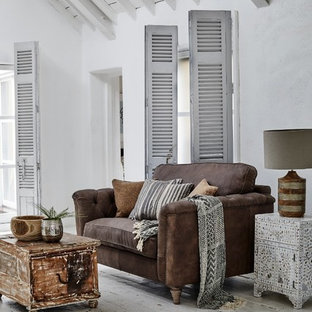 Photo of a large mediterranean living room in Other with white walls, painted wood flooring and white floors.