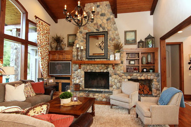 Inspiration for a large rustic formal and open concept dark wood floor living room remodel in Portland with white walls, a standard fireplace, a stone fireplace and a media wall