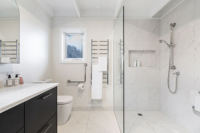 Design ideas for a mid-sized modern bathroom in Melbourne with blue cabinets.