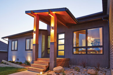Large trendy gray one-story wood house exterior photo in Vancouver