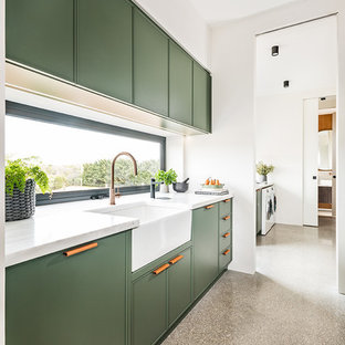 Inspiration for a mid-sized contemporary galley kitchen pantry in Melbourne with a farmhouse sink, shaker cabinets, green cabinets, marble benchtops, window splashback, panelled appliances, concrete floors, no island, grey floor and white benchtop.