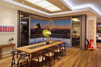 This is an example of a large contemporary eat-in kitchen in San Diego with light hardwood floors.
