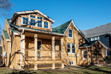 Example of a small arts and crafts beige two-story mixed siding exterior home design in Chicago with a shingle roof