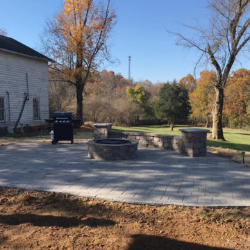 new install curved paver patio with seat wall and firepit