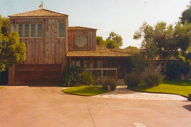 Example of a country red two-story wood exterior home design in Los Angeles