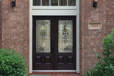 Traditional red two-story brick exterior home idea in Houston