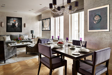 Expansive classic formal open plan living room in London with grey walls, light hardwood flooring and a wall mounted tv.