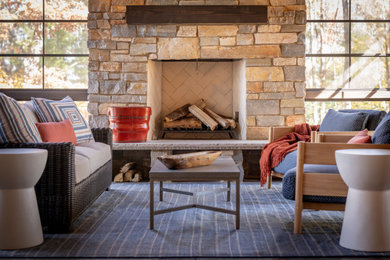 This is an example of a mid-sized rustic porch design in Other with a fireplace.