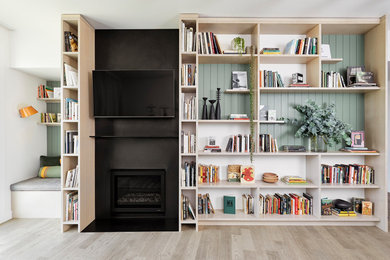 Living room - mid-sized contemporary open concept light wood floor and gray floor living room idea in Portland with white walls, a standard fireplace, a metal fireplace and a wall-mounted tv