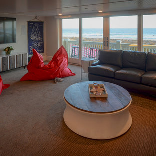 Mid-sized coastal enclosed carpeted and beige floor home theater photo in Charleston with white walls and a wall-mounted tv