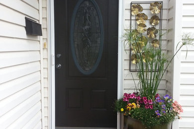 Design ideas for a mid-sized contemporary front door in Calgary with a single front door and a black front door.