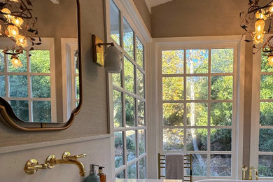 Example of a huge transitional master green tile and ceramic tile porcelain tile, double-sink, exposed beam and wallpaper bathroom design in Santa Barbara with furniture-like cabinets, light wood cabinets, a wall-mount toilet, green walls, an undermount sink, quartz countertops, a hinged shower door, white countertops and a freestanding vanity