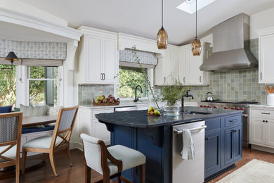 Transitional l-shaped dark wood floor, brown floor and vaulted ceiling eat-in kitchen photo in Baltimore with an undermount sink, beaded inset cabinets, white cabinets, green backsplash, stainless steel appliances, an island and white countertops