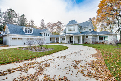 Large transitional beige two-story mixed siding and shingle exterior home photo in Other with a mixed material roof and a gray roof