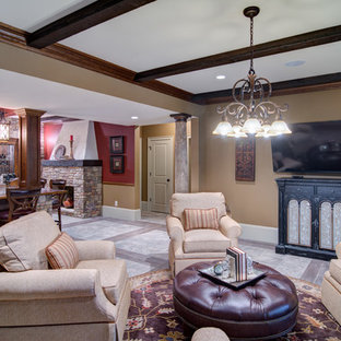 Imagen de sótano con puerta mediterráneo, grande, con paredes marrones, suelo de baldosas de porcelana, chimenea tradicional, marco de chimenea de piedra y suelo beige