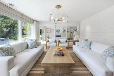 Inspiration for a mid-sized open concept beige floor living room remodel in Boston with white walls, no fireplace and a media wall