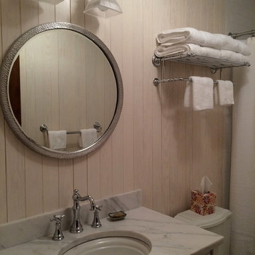Rustic Bathroom With Round Mirror and Oak Shiplap