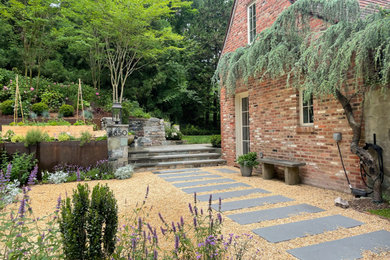 This is an example of a mid-sized transitional full sun courtyard gravel garden path in DC Metro.