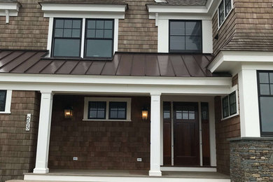 Traditional two-story wood exterior home idea in Providence with a shingle roof