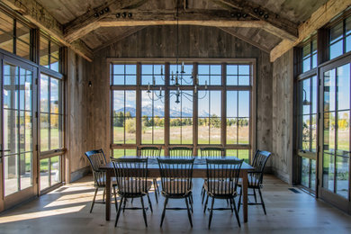 Diseño de comedor abovedado campestre con paredes marrones, suelo de madera en tonos medios, suelo marrón, vigas vistas y madera