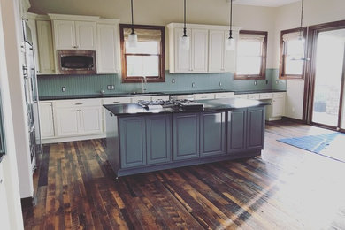 Example of a farmhouse home design design in Denver