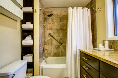 Example of a small beige tile and ceramic tile ceramic tile alcove bathtub design in Denver with an undermount sink, recessed-panel cabinets, dark wood cabinets and yellow walls