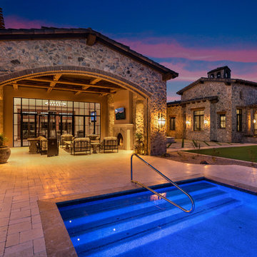 Poolside Outdoor Living Room with Arched Stone Patio