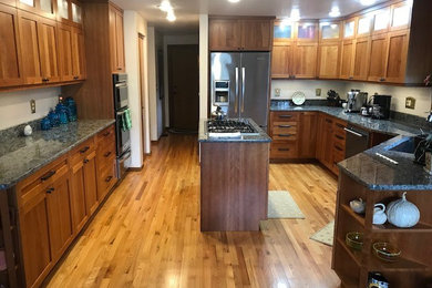 Inspiration for a mid-sized craftsman u-shaped kitchen remodel in Seattle with shaker cabinets, medium tone wood cabinets, granite countertops and an island