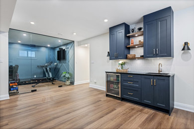 Example of a large look-out brown floor basement design in Ottawa with a bar