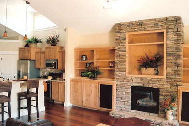 Large arts and crafts open concept medium tone wood floor family room photo in Boise with beige walls, a standard fireplace and a stone fireplace