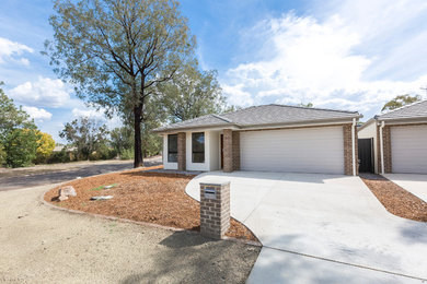 Inspiration for a mid-sized traditional one-storey brick white house exterior in Canberra - Queanbeyan with a hip roof and a tile roof.