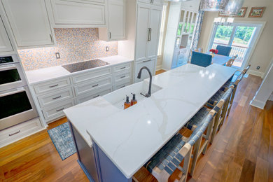 Kitchen - mid-sized country galley medium tone wood floor kitchen idea in Atlanta with a farmhouse sink, stainless steel appliances and an island