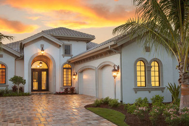 Inspiration for a large mediterranean entryway remodel in Miami with a metal front door