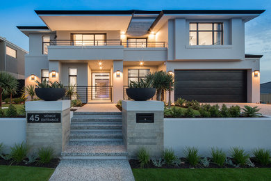 This is an example of a large contemporary two-storey brick grey house exterior in Perth with a flat roof and a tile roof.