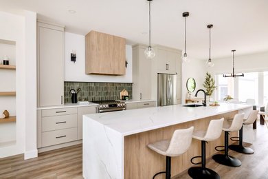 Eat-in kitchen - mid-sized contemporary single-wall laminate floor and brown floor eat-in kitchen idea in Other with an undermount sink, flat-panel cabinets, gray cabinets, quartzite countertops, green backsplash, porcelain backsplash, stainless steel appliances, an island and white countertops