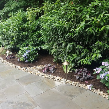 Patio with stone wall and fire pit